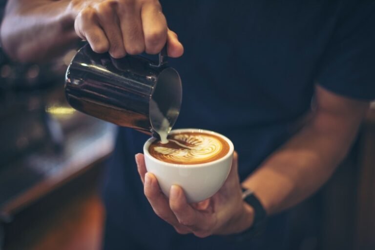 close-up-hands-barista-make-latte-coffee-art-paint